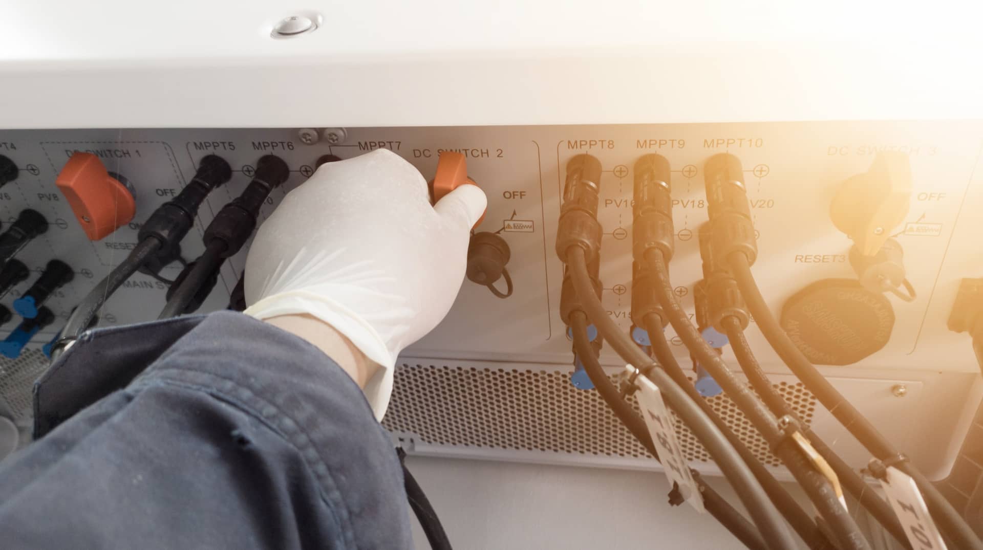Engineers hand with glove showing how to safely turn off solar system